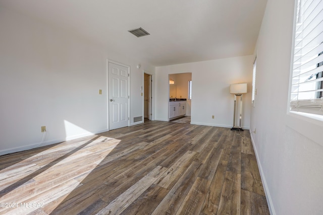 unfurnished living room with dark hardwood / wood-style flooring