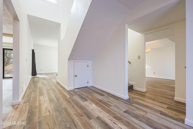 kitchen with a tray ceiling, dark hardwood / wood-style flooring, white cabinets, and appliances with stainless steel finishes