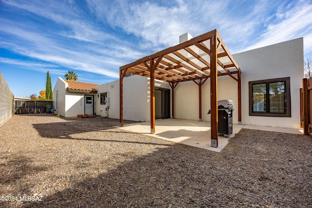 rear view of house featuring a pergola