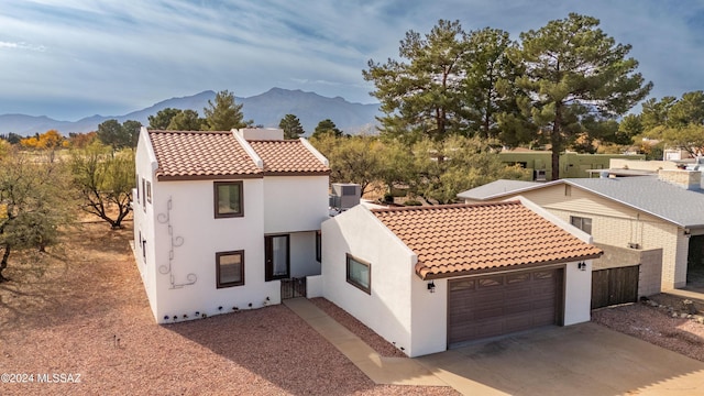 mediterranean / spanish house featuring a mountain view and a garage