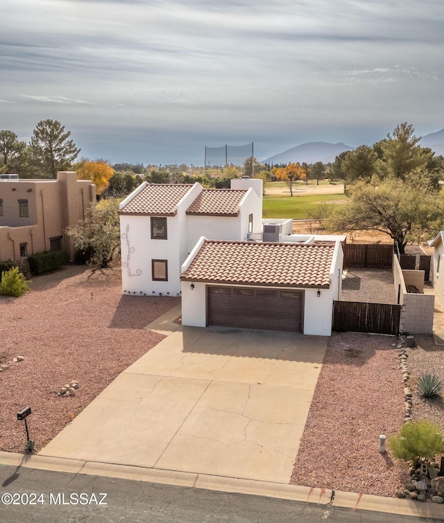 view of front of home with a mountain view and a garage