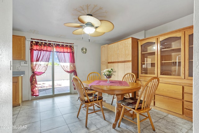 tiled dining area with ceiling fan