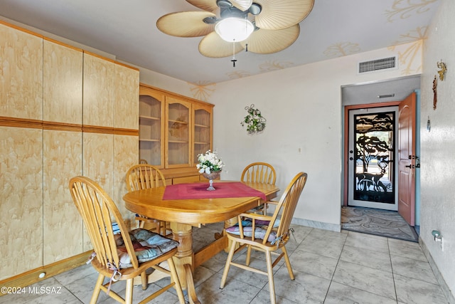 tiled dining space with ceiling fan