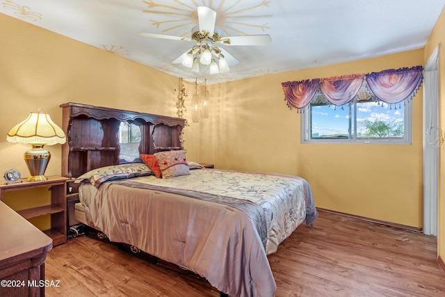 bedroom with ceiling fan and wood-type flooring