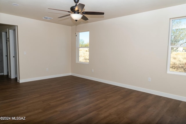 unfurnished room featuring ceiling fan and dark wood-type flooring