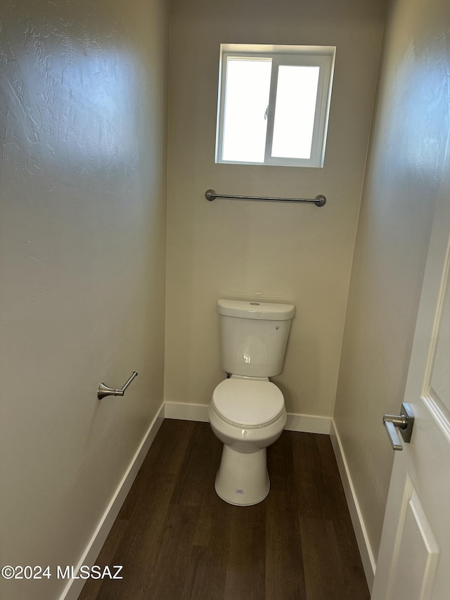 bathroom with toilet and wood-type flooring