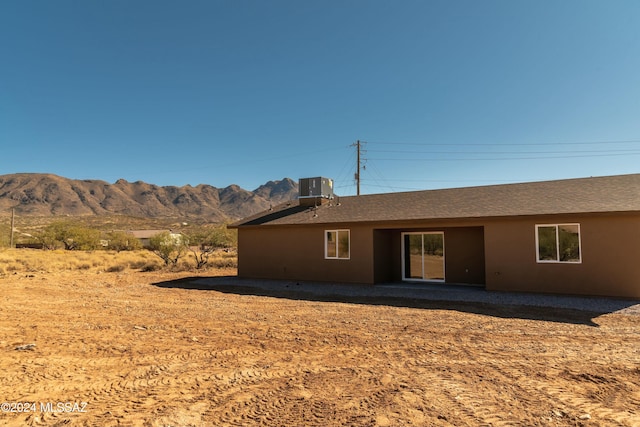 back of house with central AC and a mountain view