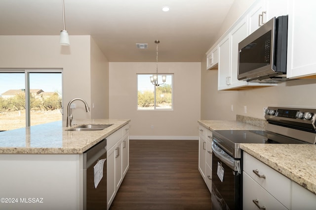 kitchen featuring sink, stainless steel appliances, dark hardwood / wood-style floors, pendant lighting, and white cabinets