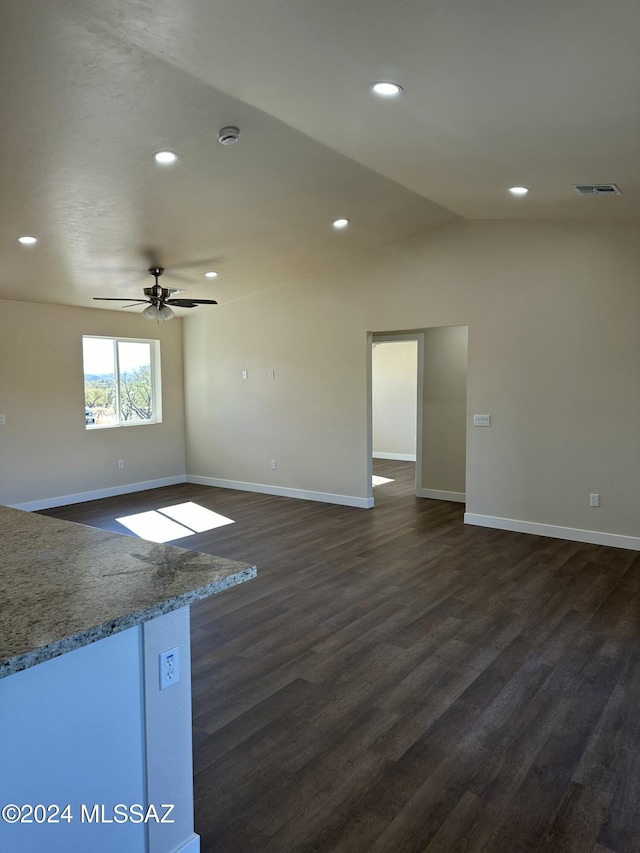 empty room featuring ceiling fan, dark wood-type flooring, and lofted ceiling