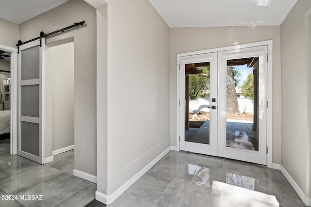 doorway with vaulted ceiling, french doors, and a barn door