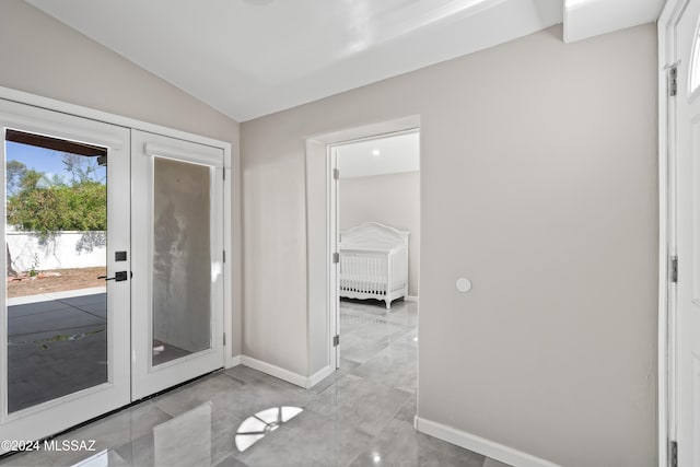 doorway to outside with french doors and lofted ceiling