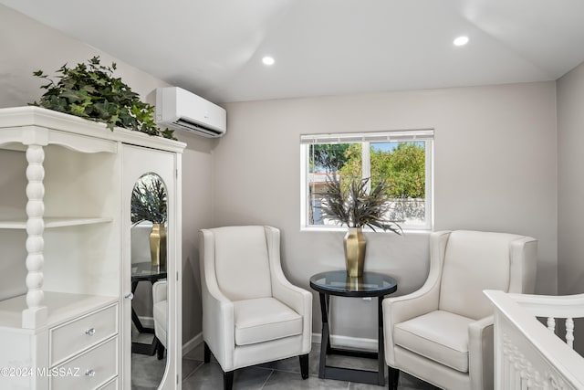 sitting room with a wall mounted AC and tile patterned floors