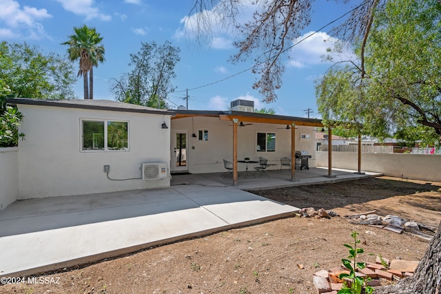 rear view of house with central AC unit and a patio area