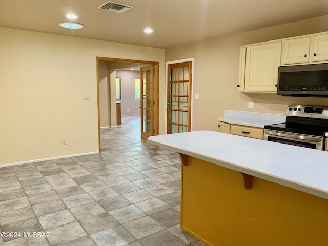 kitchen with a breakfast bar area and appliances with stainless steel finishes