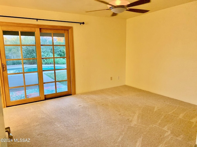 carpeted empty room with ceiling fan