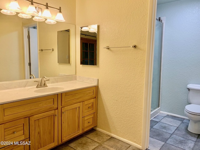 bathroom with tile patterned flooring, vanity, toilet, and an enclosed shower