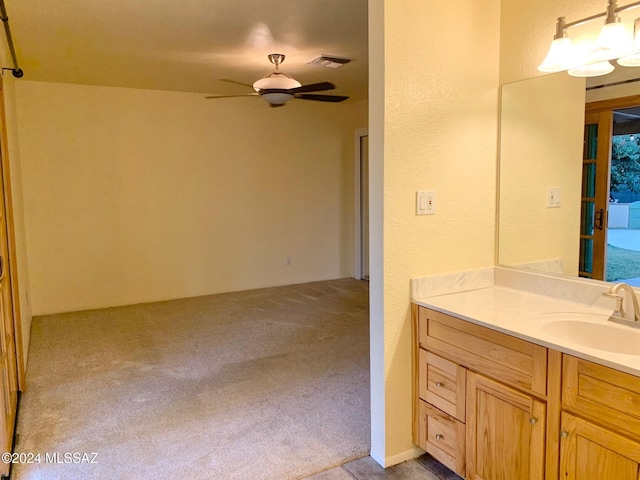 bathroom with ceiling fan and vanity