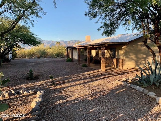 rear view of property featuring a mountain view and a patio