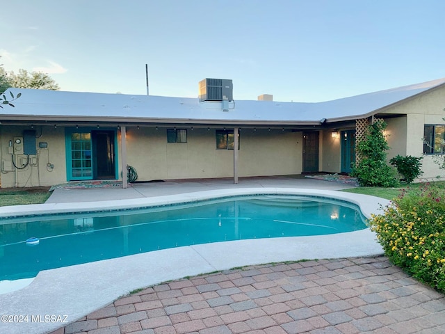 view of swimming pool with a patio area and central air condition unit