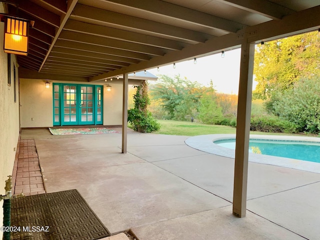 view of pool featuring a patio area and french doors