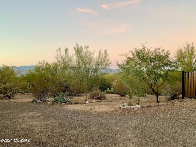 yard at dusk featuring a mountain view