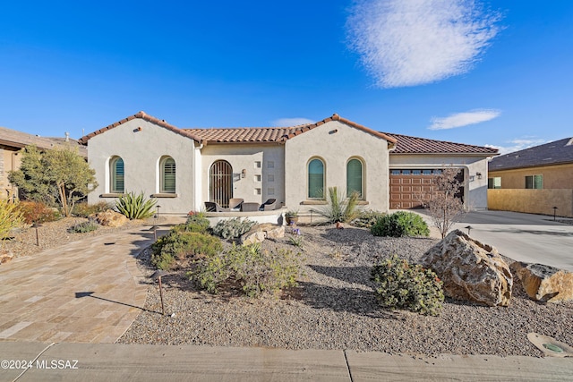 mediterranean / spanish-style house featuring a garage