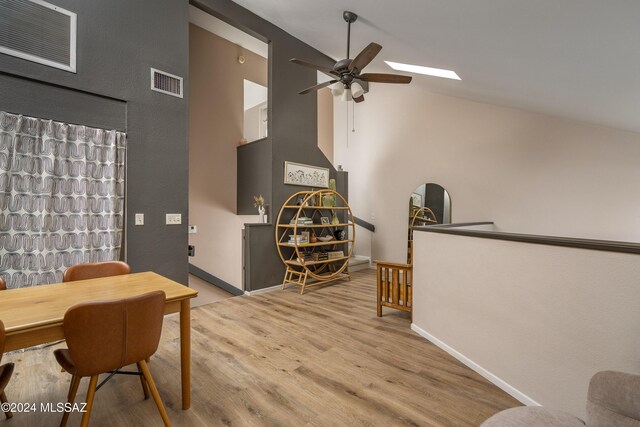 dining room featuring ceiling fan, high vaulted ceiling, and light hardwood / wood-style flooring