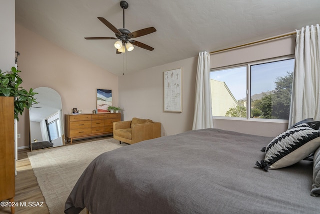 bedroom with hardwood / wood-style floors, ceiling fan, and lofted ceiling