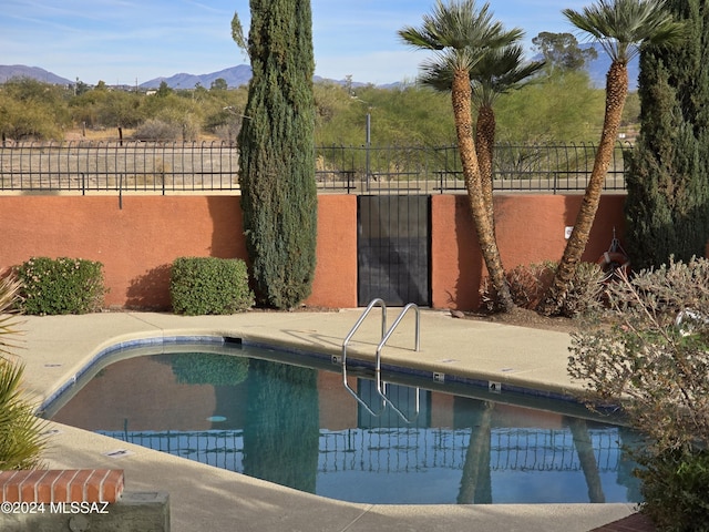 view of pool with a patio area and a mountain view