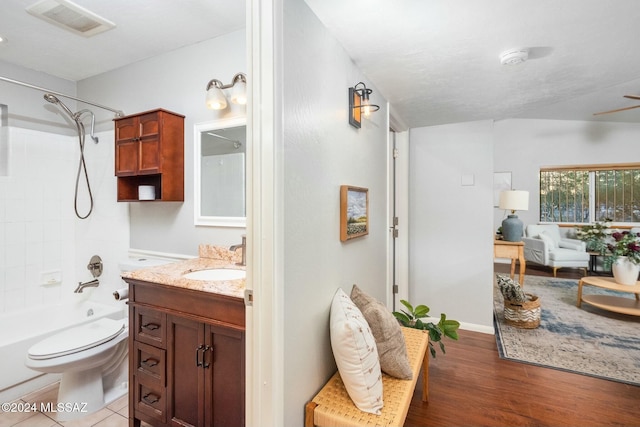 full bathroom with hardwood / wood-style floors, vanity, toilet, and bathtub / shower combination