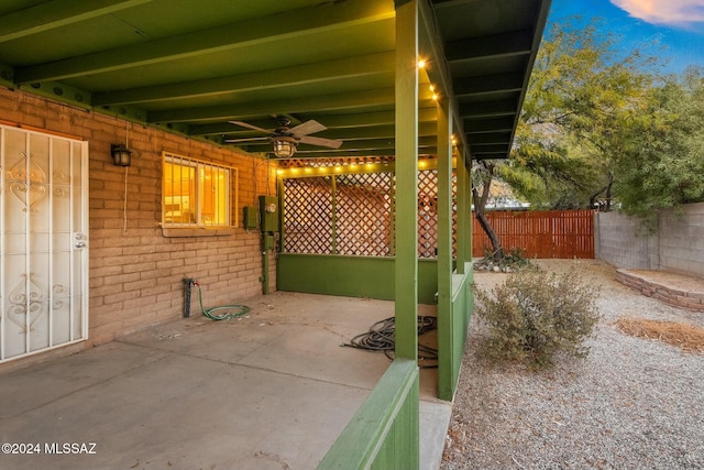 patio terrace at dusk featuring ceiling fan