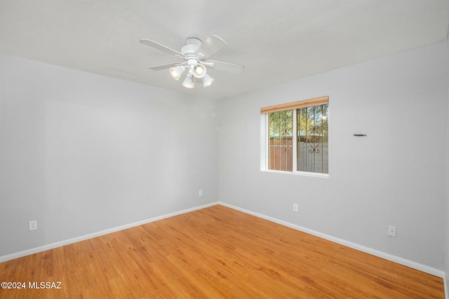 empty room with ceiling fan and hardwood / wood-style floors