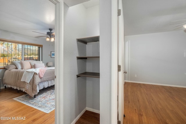 bedroom with hardwood / wood-style floors and ceiling fan