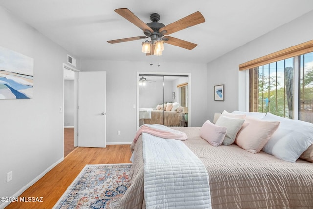 bedroom with ceiling fan, a closet, and light hardwood / wood-style floors