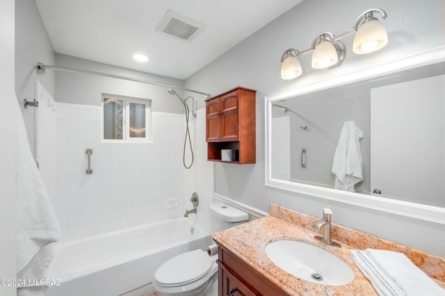 full bathroom with vanity, toilet, and tiled shower / bath