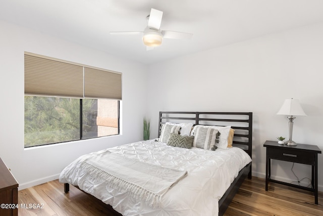 bedroom with ceiling fan and wood-type flooring