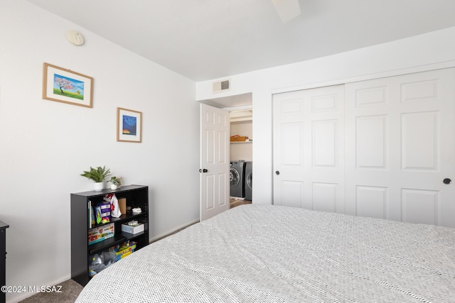 bedroom with carpet, independent washer and dryer, and a closet