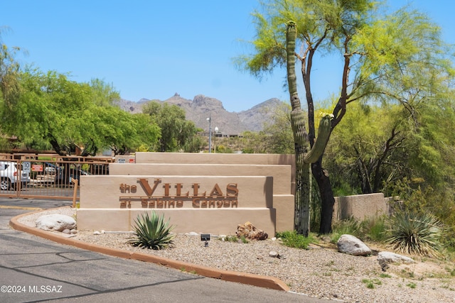 community sign with a mountain view