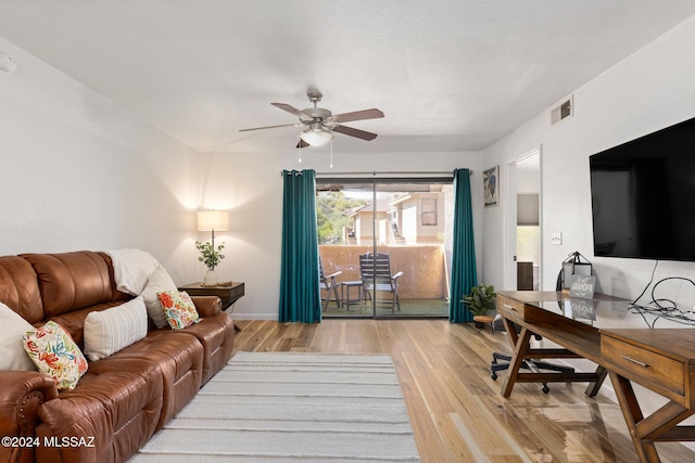 living room featuring light hardwood / wood-style floors and ceiling fan