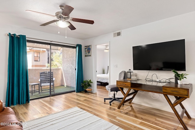 office with ceiling fan and light wood-type flooring