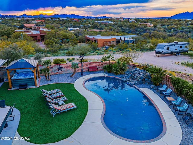 view of pool at dusk