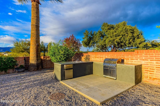 view of patio featuring area for grilling, sink, and an outdoor kitchen