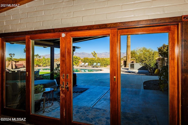 doorway to outside with a mountain view and french doors