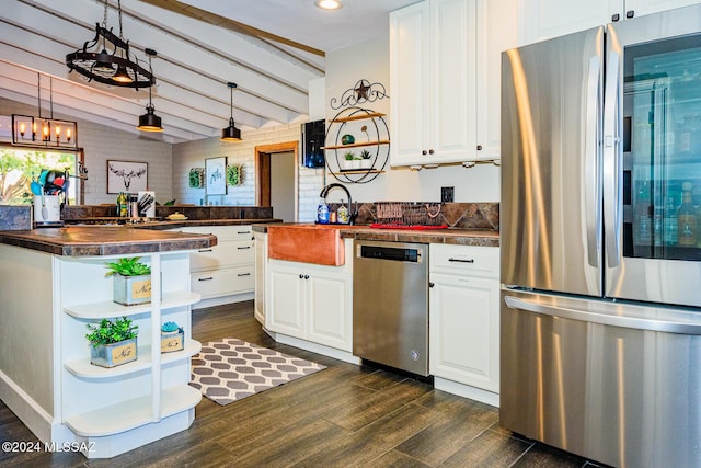 kitchen featuring appliances with stainless steel finishes, decorative light fixtures, and white cabinetry