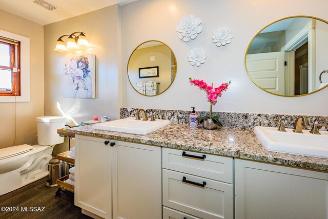 kitchen featuring white cabinets, beamed ceiling, decorative light fixtures, stainless steel appliances, and brick wall