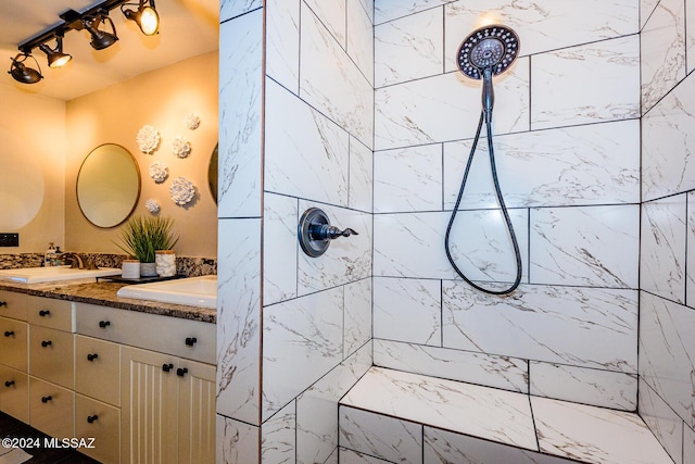 bathroom with vanity and tiled shower