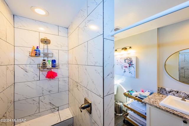 bathroom featuring vanity and a tile shower