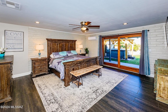 bedroom featuring access to exterior, ceiling fan, dark hardwood / wood-style flooring, and brick wall