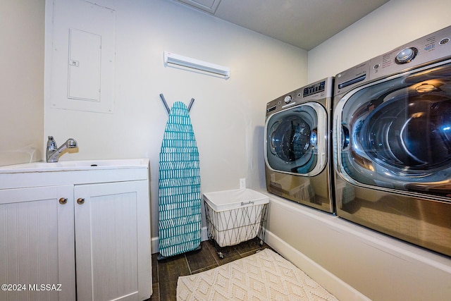 clothes washing area with cabinets, electric panel, sink, dark hardwood / wood-style flooring, and washing machine and clothes dryer