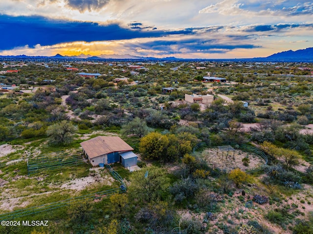 aerial view at dusk featuring a mountain view